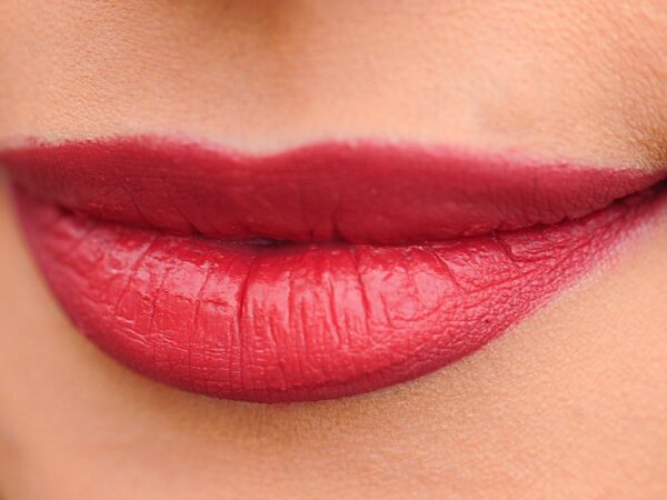 a photo of a woman's lips with red lipstick on